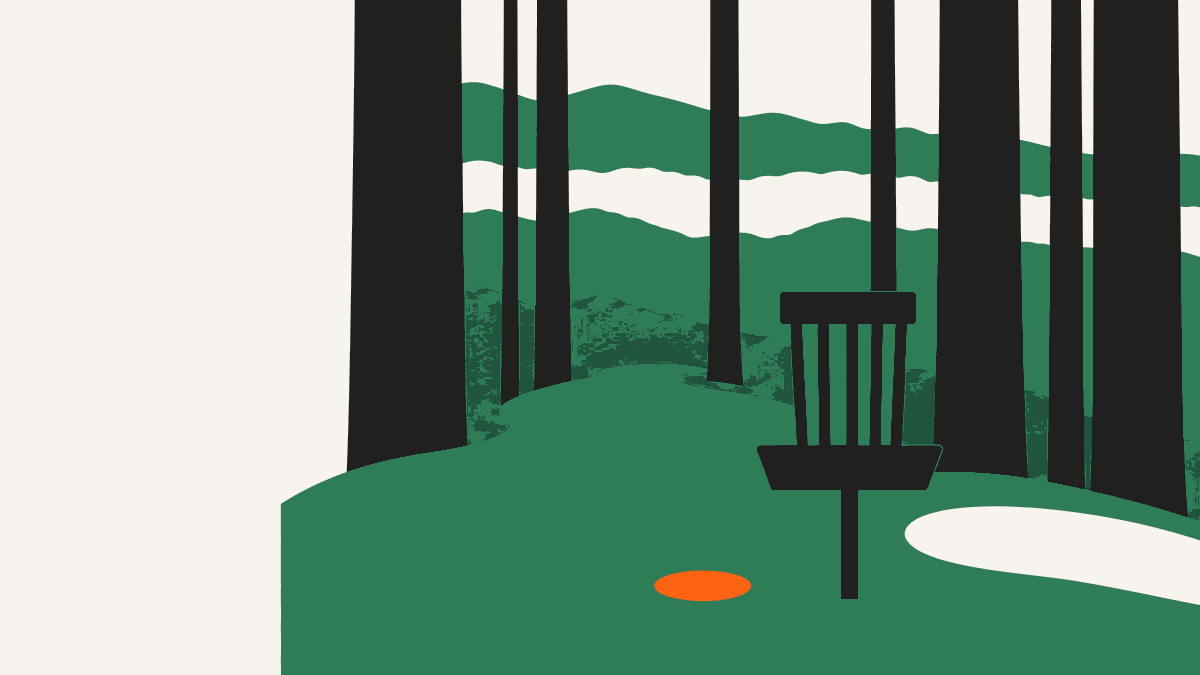 A disc golf basket on a mown green among giant coast redwoods, the Santa Cruz Mountains and a band of coastal fog behind it.